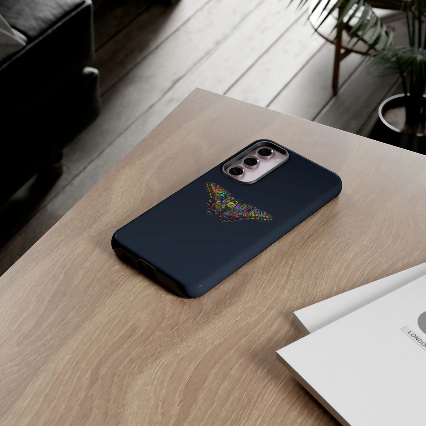 Phone case with recovery butterfly design on a wooden table