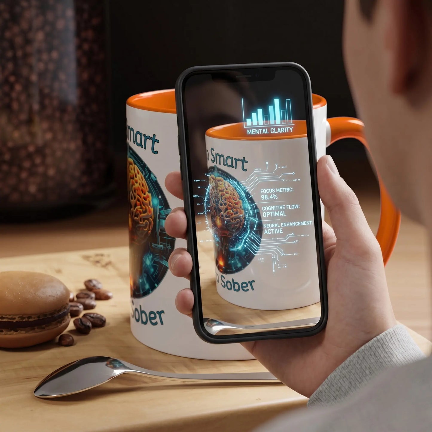 Person holding a smartphone with a coffee mug displaying brain graphics and text on a wooden table.