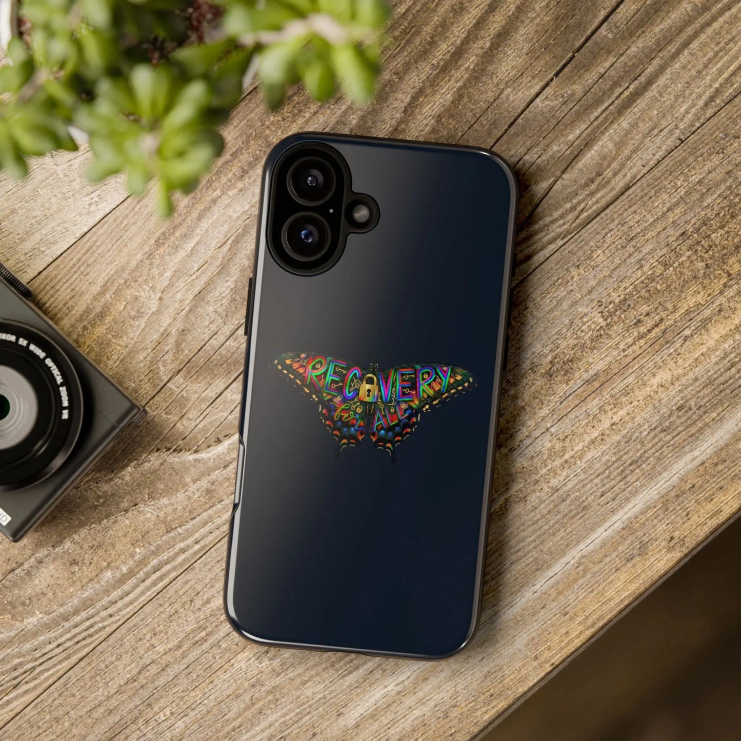 Phone case with colorful butterfly design on a wooden surface
