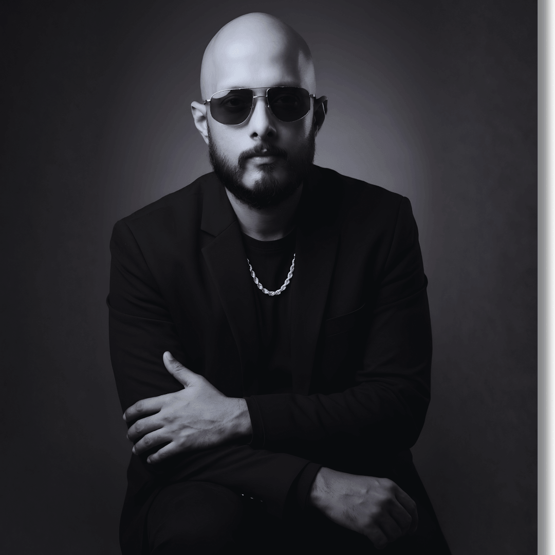 Black and white portrait of owner N.V.Shashank wearing sunglasses and a dark outfit enjoying Sobriety Life Style with SoberSips